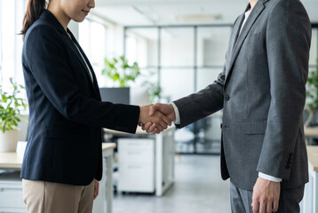 Business handshake in modern office setting