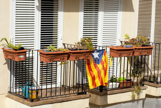 Regional flag of Catalonia flies on the balcony of a residential