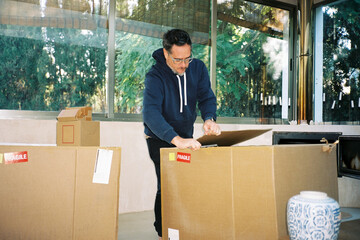 Man Opening Fragile Package Box
