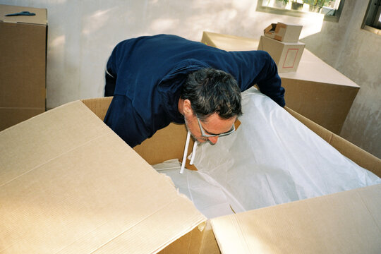 Man Unpacking New Armchair
