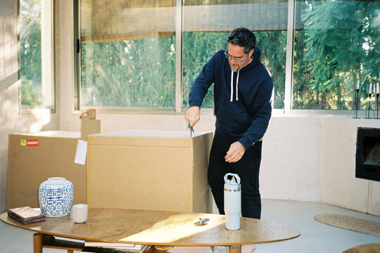 Man Opening Cardboard Box
