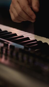 Hands Create Magic on Piano Keys in a Cozy Space