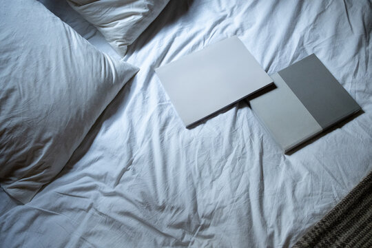 Top View of Bed With Two Books On Top of It
