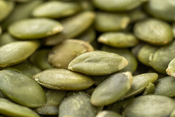 Green Pumpkin seeds isolated closeup photo.