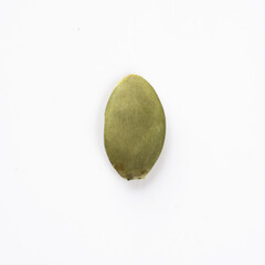 Green Pumpkin seeds closeup placed on a white background.