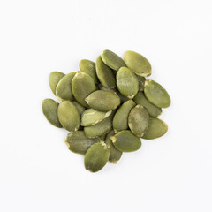 Green Pumpkin seeds closeup placed on a white background.