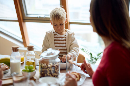 Mother and son are having breakfast
