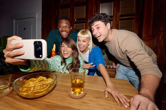 Friends capturing selfies at home