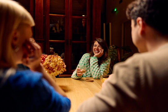 Happy woman sits with her firends at home