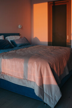 Cozy Bedroom Bathed in Warm Evening Light Creates a Serene Atmosphere