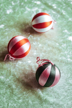 Colorful decorative balls on green surface