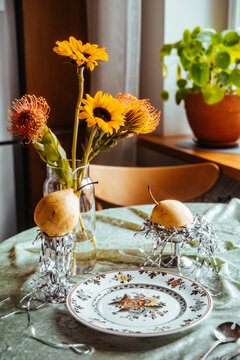 Sunny flowers and fresh pears on table