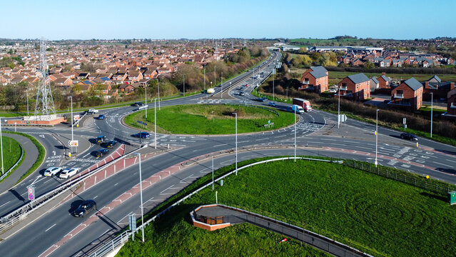 Above a roundabout with a city in the background
