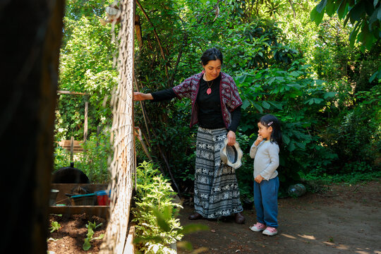 Latina Mother and Child in Shaded Garden Corner