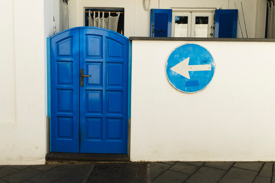 Blue door and arrow sign