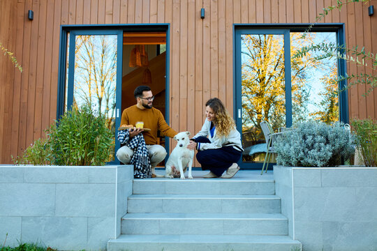 Couple sits on the doorstep of the cabin