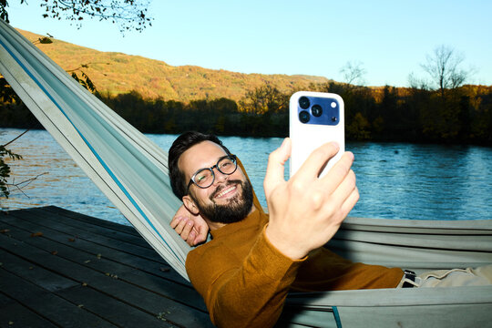 Happy man take selfies by the river