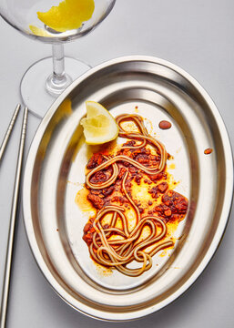 Still life of leftover noodles on a silver plate