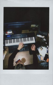 A professional composer creates music in a home music studio