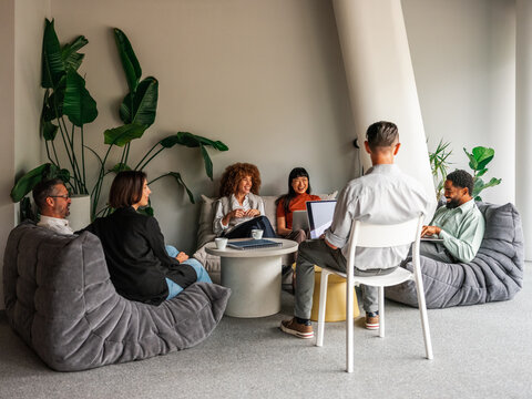 Casual Office Lounge Meeting With Diverse Team Laughing, Working