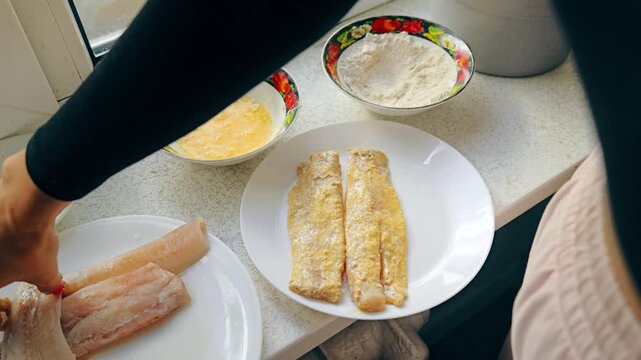 Pollock fillet is breaded with flour, egg on kitchen counte, healthy lifestyle