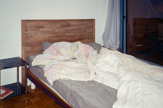 Blankets and Pillows Scattered Across a Cozy Bedroom Bed