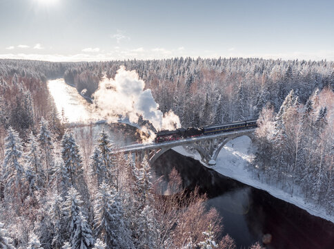 Steam train on the bridge, winter season