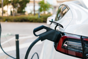 Electric car charging at station for sustainable future