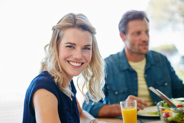 Portrait, lunch and woman with husband in home for romantic date, anniversary celebration and bonding. Happiness, food and conversation with couple eating in dining room of apartment for connection