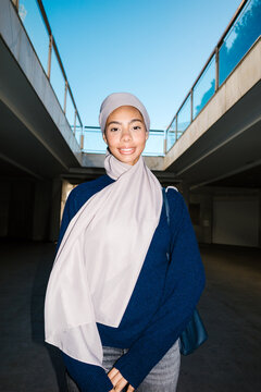 Smiling young woman wearing hijab in urban setting