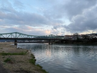 Fototapeta premium Moody riverside landscape in rural Japan with a vintage pier with copy space