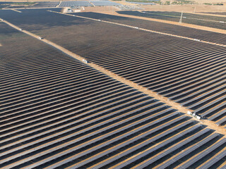 Rows of solar panels on dry rural land