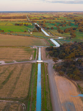 Irrigation channel running across farmland toward the horizon
