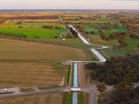 Irrigation channel running across farmland toward the horizon