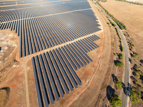 Rows of solar panels on dry rural land