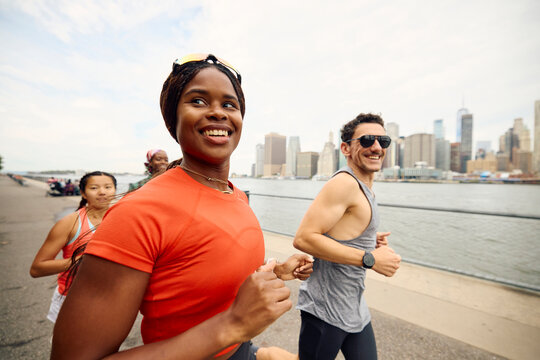 People jogging along the riverbank in New York