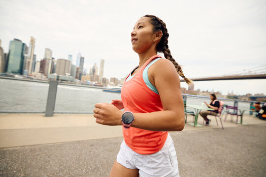 Woman runs by the East River