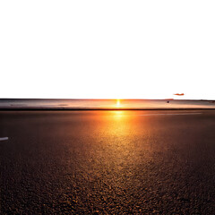 Asphalt road reflects sunset's distant glow