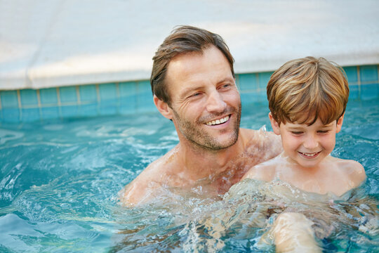 Happy dad, child and swimming in pool for playful holiday, weekend or outdoor summer break. Father, kid or playing with son or boy in water for bonding, fun childhood or aqua safety in backyard