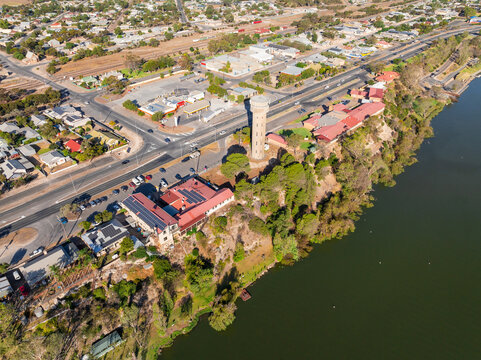 Regional town with a tall water tower on a riverbank