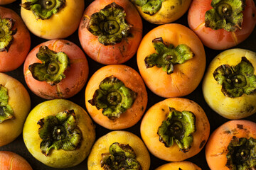 Full frame still life of fresh ripe persimmons