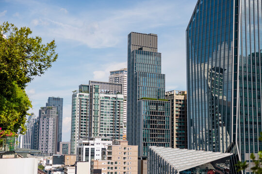 Cityscape with modern skyscrapers against a blue sky.