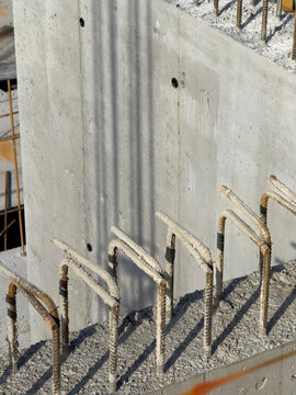 Bent Rebar Bars Emerging from Brutalist Concrete Shear Wall Surface