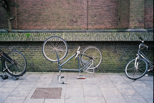 Bikes Parked on a City Street With One Bike Flipped Upside Down