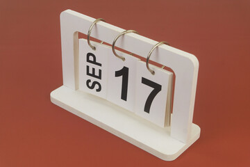 September 17 on calendar on brown background	