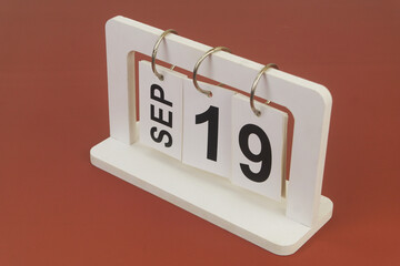 September 19 on calendar on brown background	