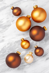 Luxury Christmas ball ornaments on white marble table, top view