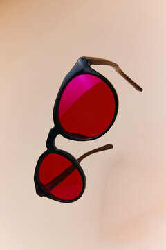 Stylish Red Lens Sunglasses with Black Frame Floating 