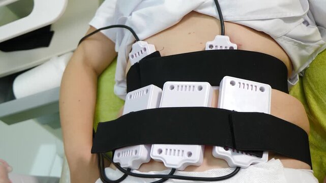 Lipo laser equipment on female body in medicine salon or modern beauty clinic. Body care. Fast fat burning. wellness center with weight loss procedures. 4 k video
