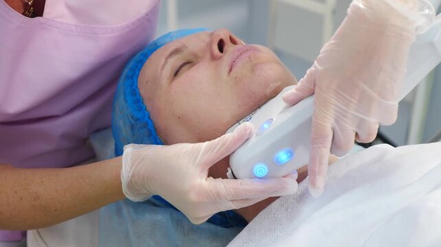 Smas lifting anti-aging therapy. Hardware cosmetology concept. non-surgical face lifting treatment. ultrasonic device, facial skin rejuvenating procedure in modern beauty clinic. wrinkle reducing on